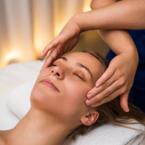 Woman relaxing during a facial massage